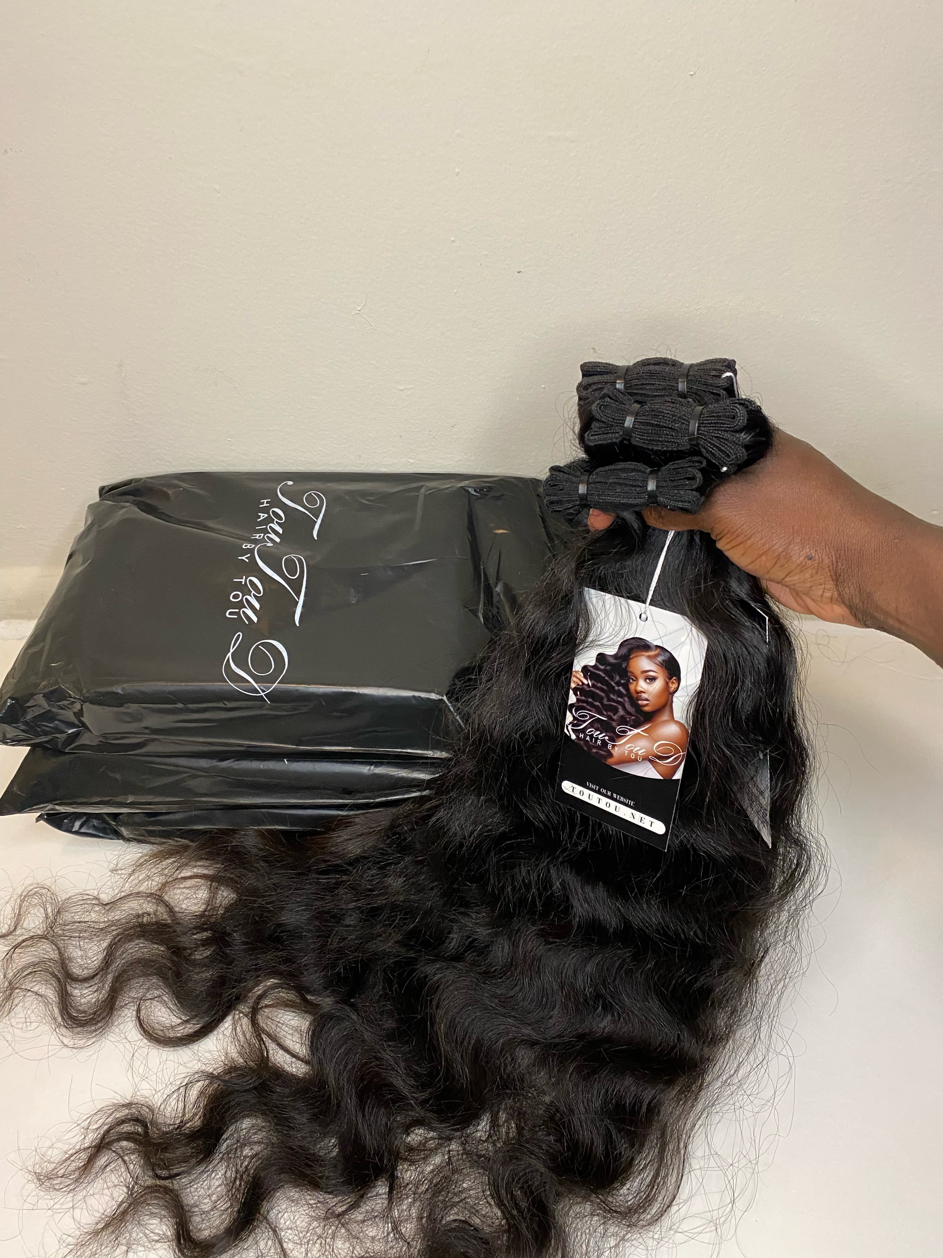 TouTouD raw hair bundles with the branded hang tag and mailer bags