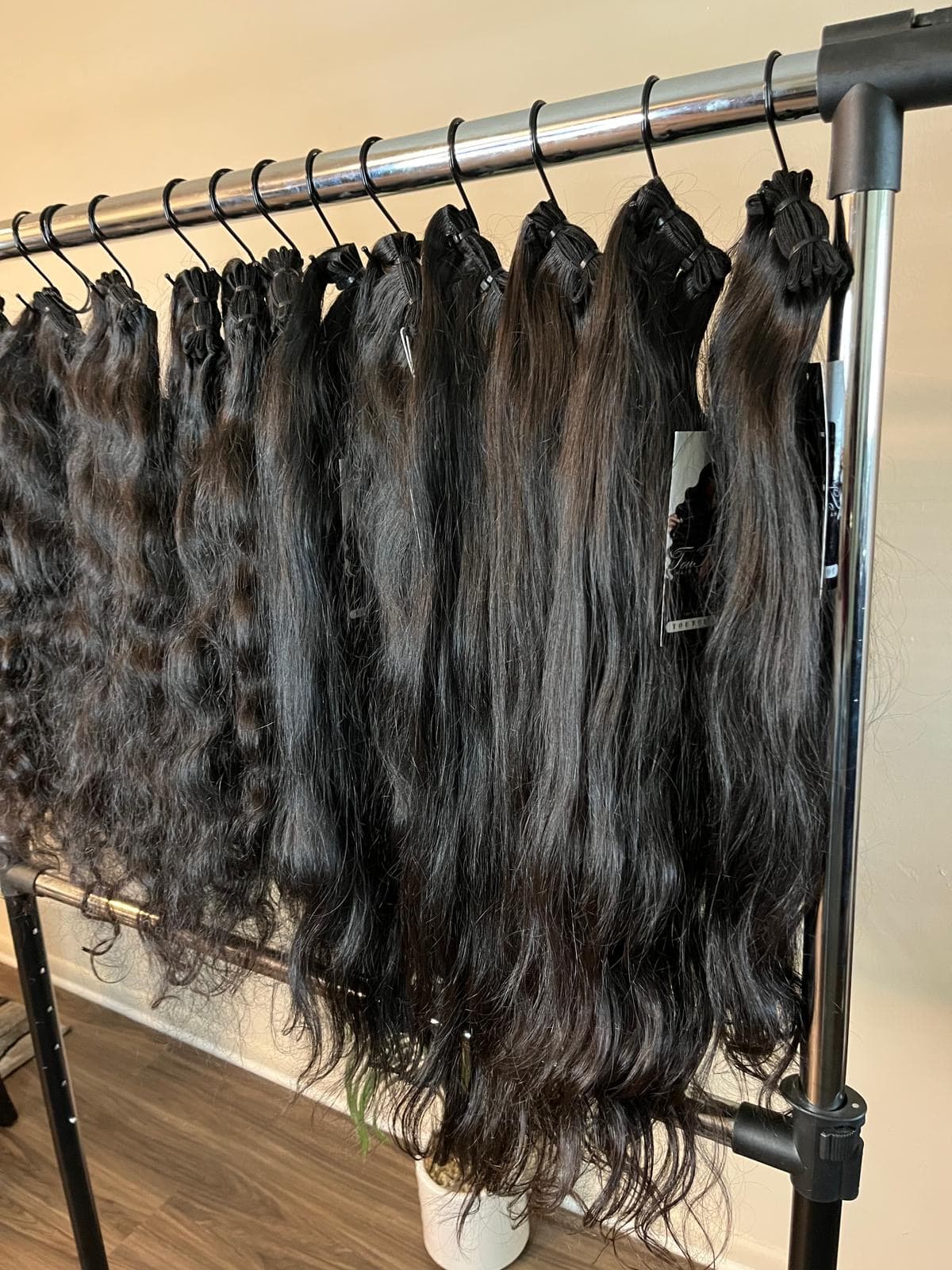 Raw hair bundles hanging on the TouTouD rack